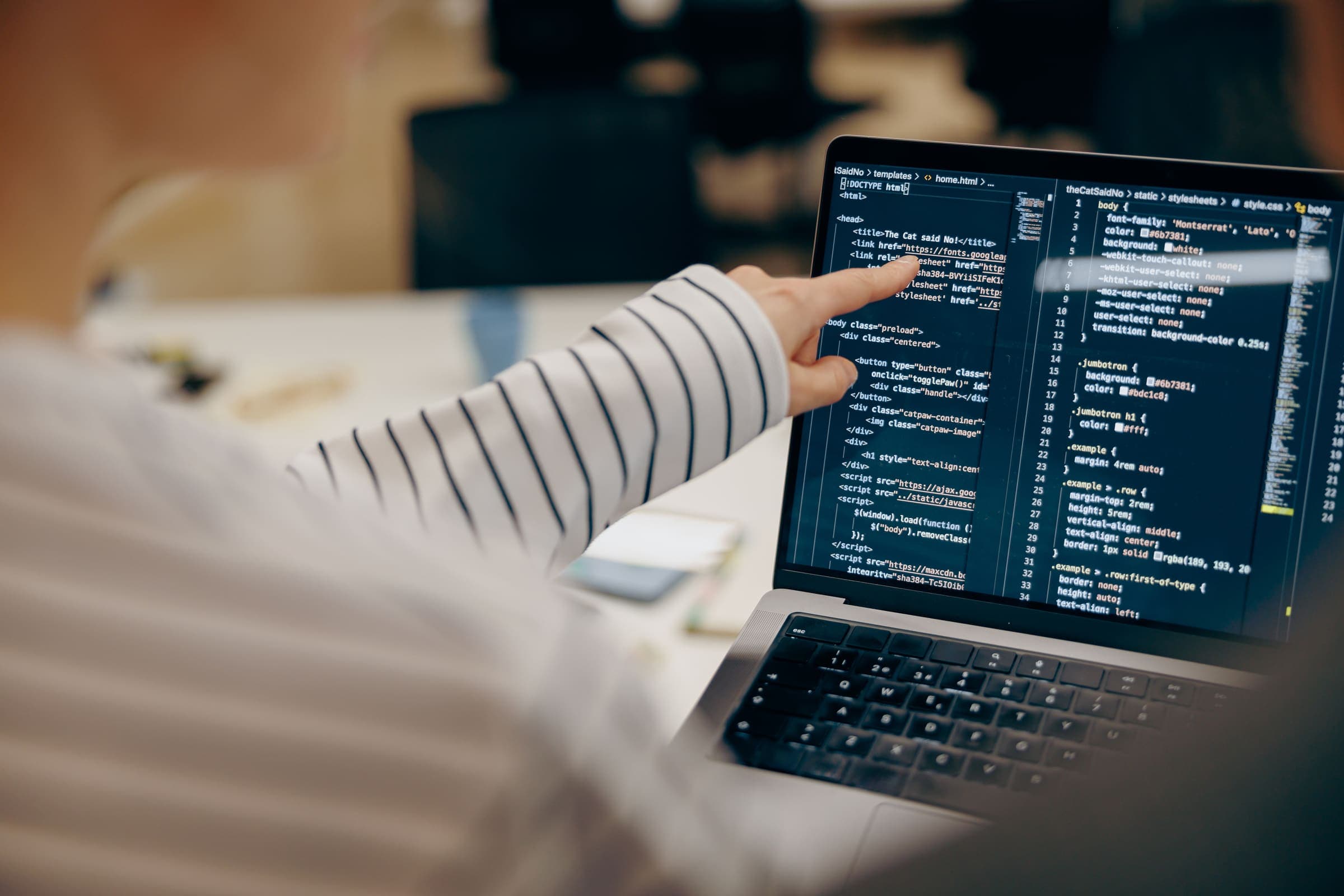 IT professional reviewing code on a laptop screen
